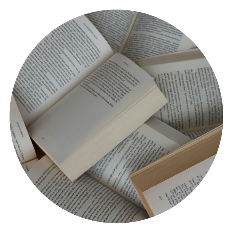 a pile of open books to show storytelling