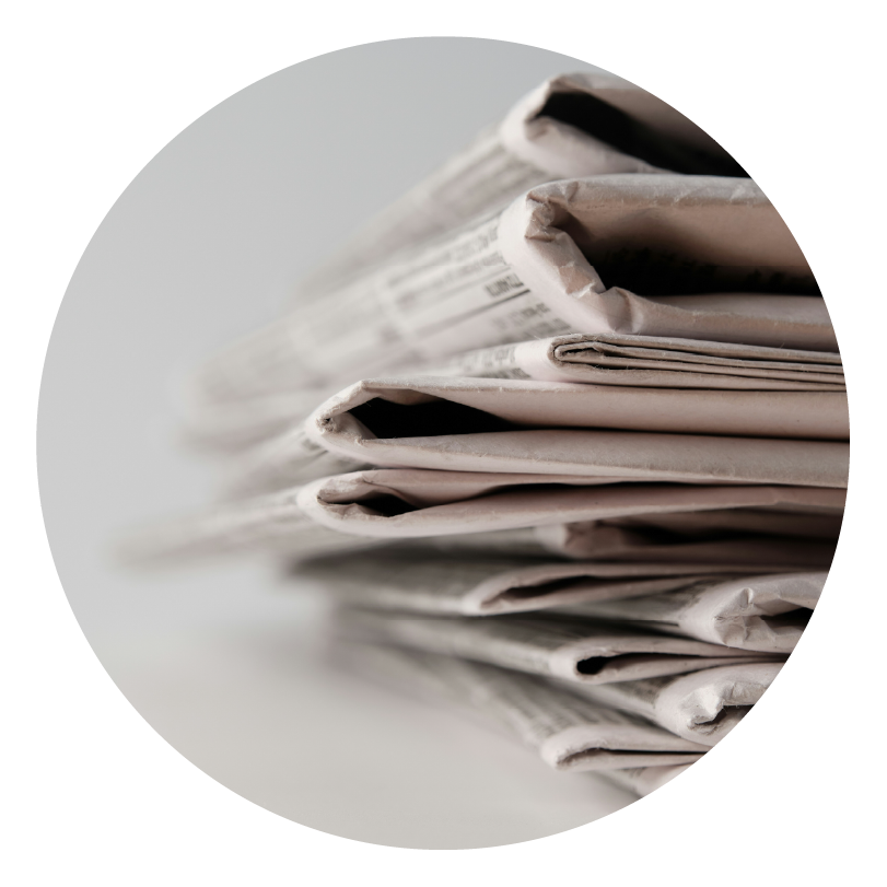 a close up of stack of old newspapers showing the most important news and not burying the lead